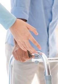 Portrait of Asian young nurse helping old elderly disable man grandfather to walk by using walker equipment in the bedroom. Senior patient of nursing home moving with walking frame and nurse support